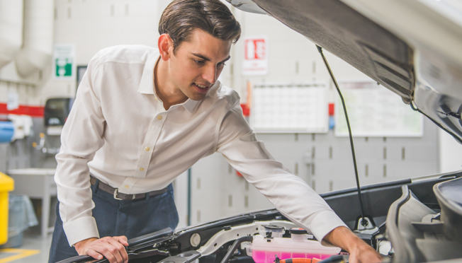 Male checking car engine